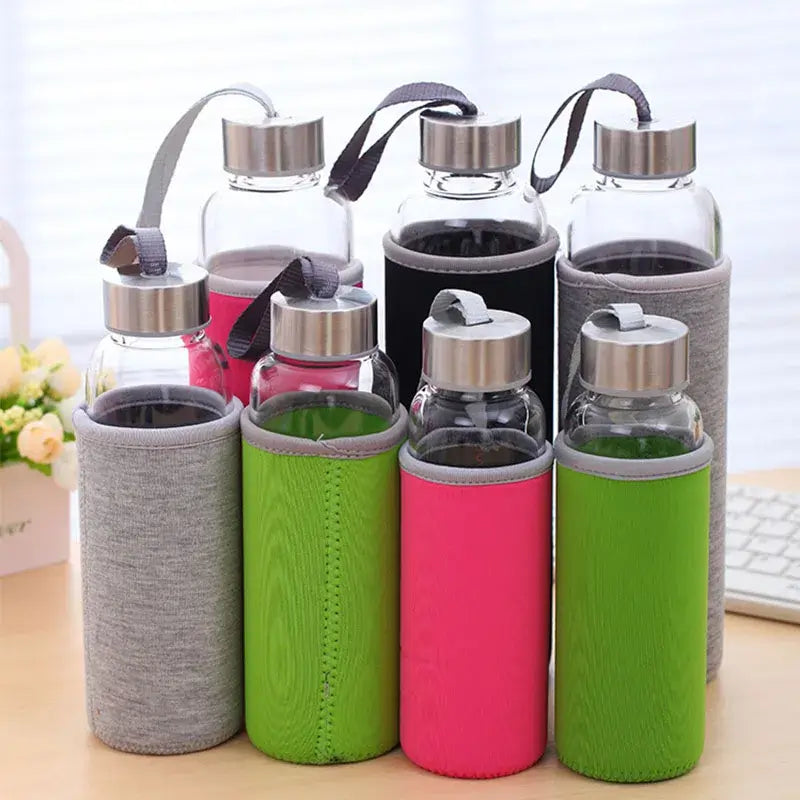 Set_of_glass_water_bottles_with_colorful_sleeves_on_a_desk.